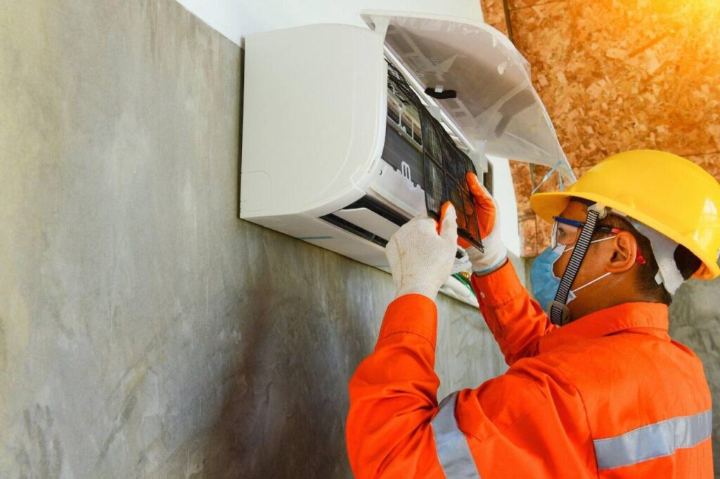 Technician-performing-annual-air-conditioning-maintenance